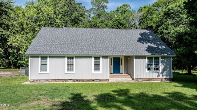 single story home with a chimney, roof with shingles, a front yard, and crawl space