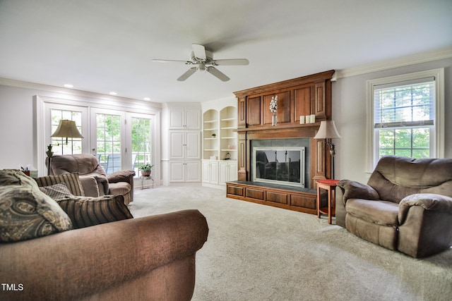 carpeted living area featuring a large fireplace, ornamental molding, recessed lighting, and ceiling fan
