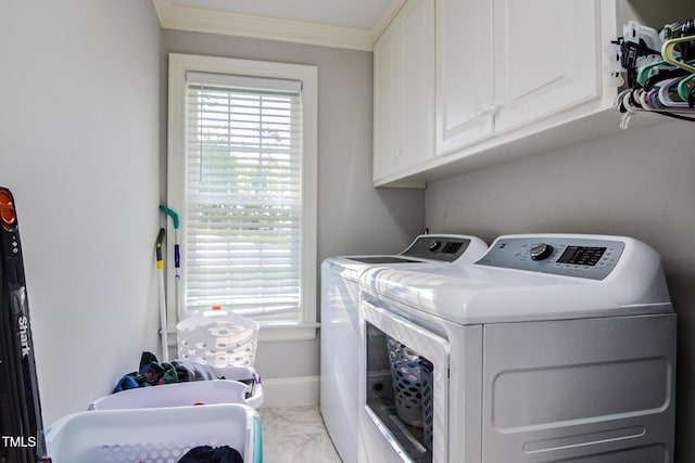 clothes washing area featuring ornamental molding, marble finish floor, baseboards, cabinet space, and independent washer and dryer