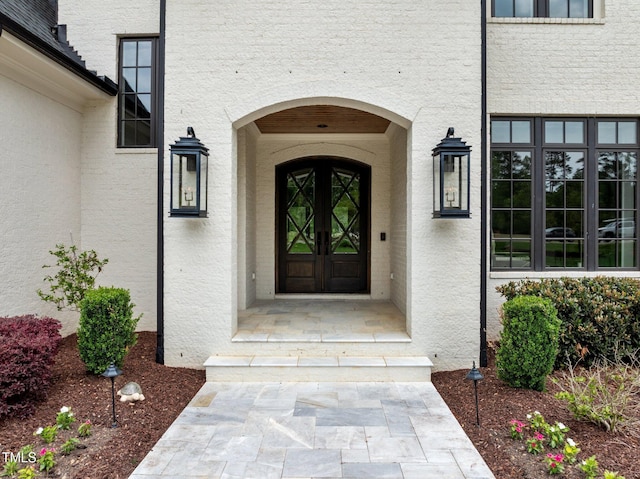 doorway to property with stucco siding and french doors