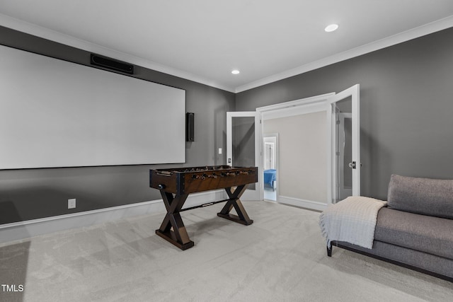 cinema room with ornamental molding, recessed lighting, light colored carpet, and baseboards
