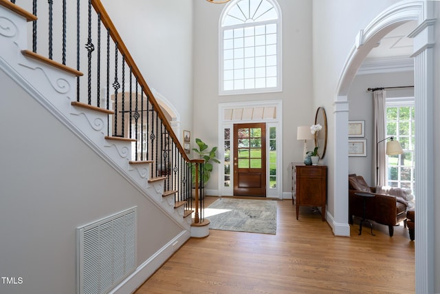 139 Stonebridge Dr, New London, NC 28127 - entryway with visible vents, arched walkways, wood finished floors, a high ceiling, and stairs