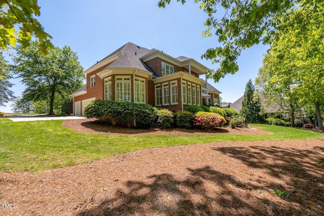 139 Stonebridge Dr, New London, NC 28127 - rear view of property with driveway, a yard, an attached garage, and brick siding