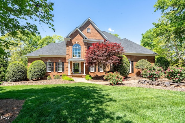 139 Stonebridge Dr, New London, NC 28127 - view of front of home with roof with shingles, a front yard, and brick siding