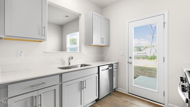 404 Ember St, Sanford, NC 27330 - kitchen with light countertops, light wood-style floors, appliances with stainless steel finishes, and a sink