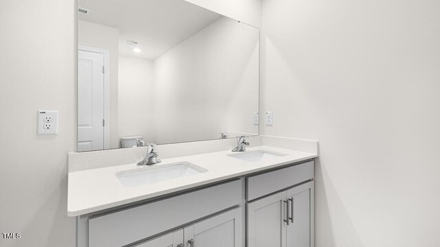 404 Ember St, Sanford, NC 27330 - bathroom featuring visible vents, a sink, double vanity, and toilet