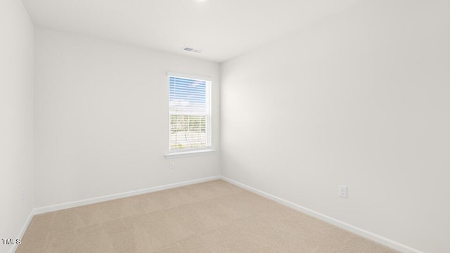 404 Ember St, Sanford, NC 27330 - unfurnished room with baseboards, visible vents, and light colored carpet
