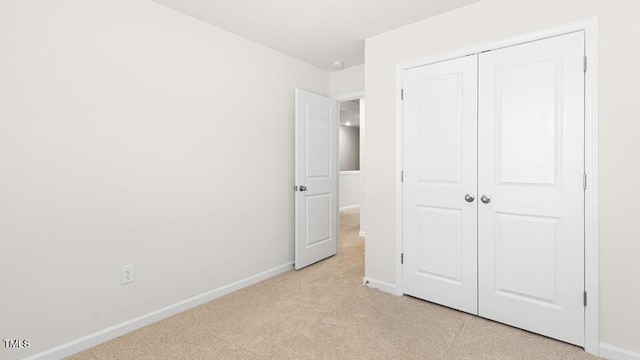 404 Ember St, Sanford, NC 27330 - unfurnished bedroom featuring baseboards, a closet, and light colored carpet