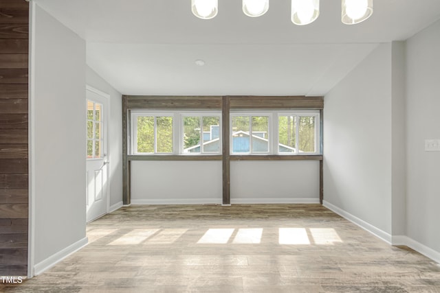 108 Carmichael Ln, Spring Lake, NC 28390 - unfurnished room with baseboards, light wood-style floors, and lofted ceiling