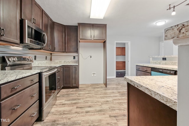 108 Carmichael Ln, Spring Lake, NC 28390 - kitchen featuring light wood-type flooring, dark brown cabinets, appliances with stainless steel finishes, and light countertops
