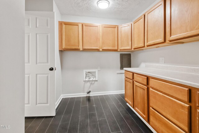 108 Carmichael Ln, Spring Lake, NC 28390 - washroom featuring a textured ceiling, cabinet space, dark wood-style flooring, and baseboards