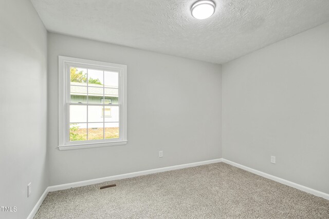 108 Carmichael Ln, Spring Lake, NC 28390 - carpeted empty room with a textured ceiling, visible vents, and baseboards