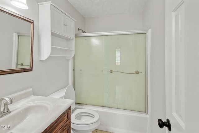 108 Carmichael Ln, Spring Lake, NC 28390 - bathroom featuring toilet, a textured ceiling, bath / shower combo with glass door, and vanity