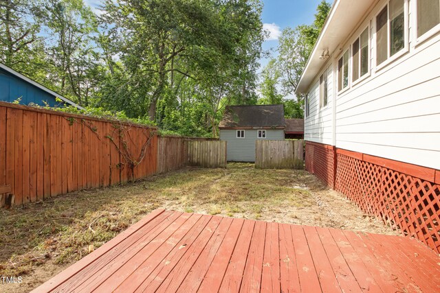 108 Carmichael Ln, Spring Lake, NC 28390 - wooden terrace featuring a storage unit, a fenced backyard, and an outdoor structure