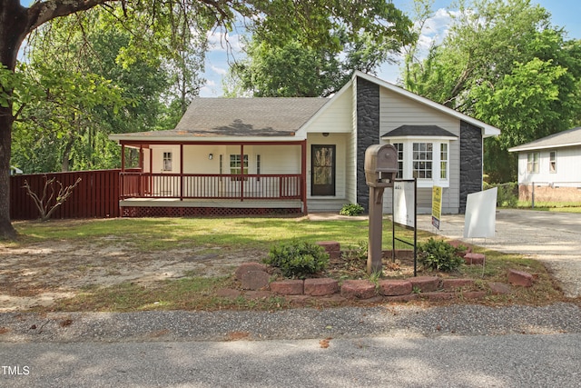 108 Carmichael Ln, Spring Lake, NC 28390 - view of front of home with a shingled roof, covered porch, and fence