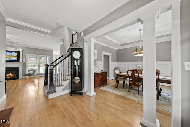 925 Hidden Jewel Ln, Wake Forest, NC 27587 - foyer featuring wood finished floors, a glass covered fireplace, ornamental molding, decorative columns, and stairway