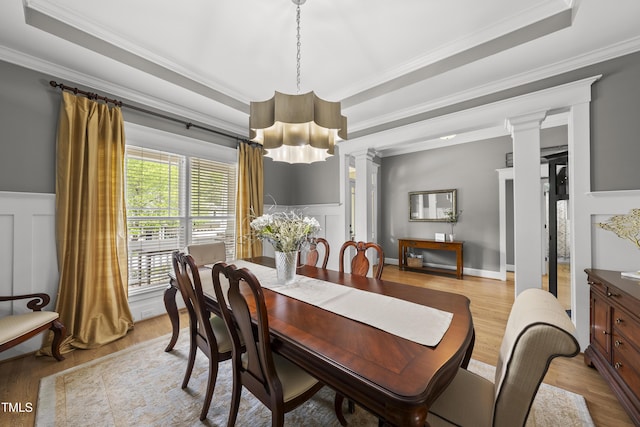 925 Hidden Jewel Ln, Wake Forest, NC 27587 - dining space with a tray ceiling, light wood-type flooring, ornamental molding, a chandelier, and decorative columns