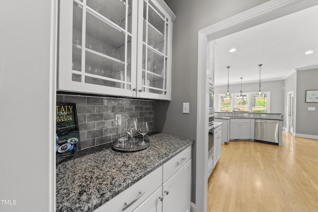 925 Hidden Jewel Ln, Wake Forest, NC 27587 - bar with appliances with stainless steel finishes, backsplash, a sink, light wood-type flooring, and hanging light fixtures