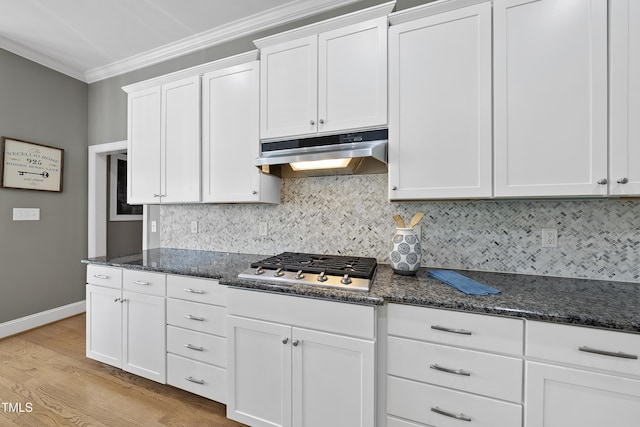 925 Hidden Jewel Ln, Wake Forest, NC 27587 - kitchen featuring under cabinet range hood, crown molding, stainless steel gas cooktop, white cabinets, and tasteful backsplash