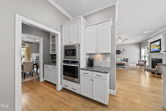 925 Hidden Jewel Ln, Wake Forest, NC 27587 - kitchen with appliances with stainless steel finishes, ornamental molding, open floor plan, light wood-style floors, and tasteful backsplash