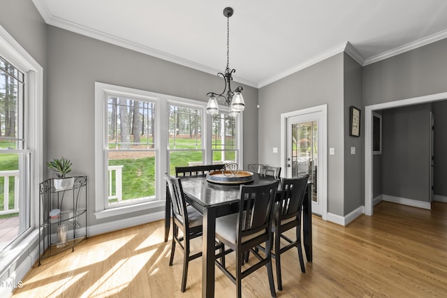 925 Hidden Jewel Ln, Wake Forest, NC 27587 - dining space with baseboards, light wood finished floors, a chandelier, and crown molding