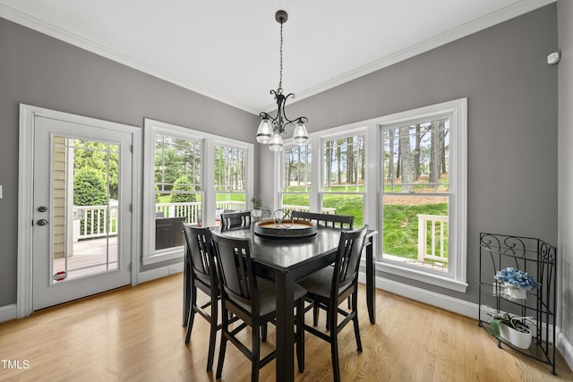 925 Hidden Jewel Ln, Wake Forest, NC 27587 - dining area featuring crown molding, a chandelier, baseboards, and light wood-type flooring