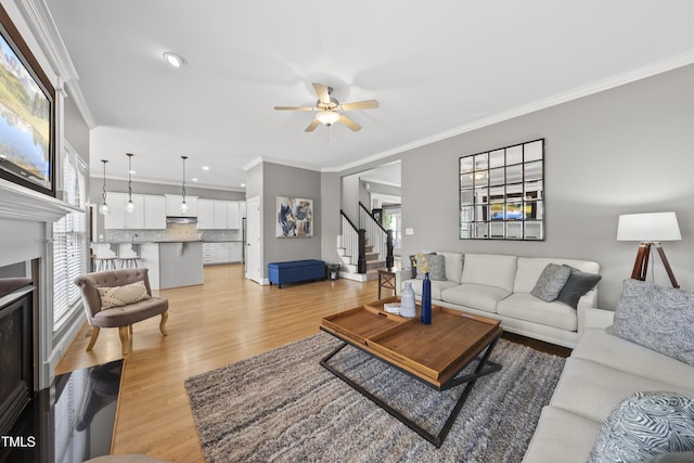 925 Hidden Jewel Ln, Wake Forest, NC 27587 - living area featuring crown molding, stairway, ceiling fan, light wood-style flooring, and recessed lighting