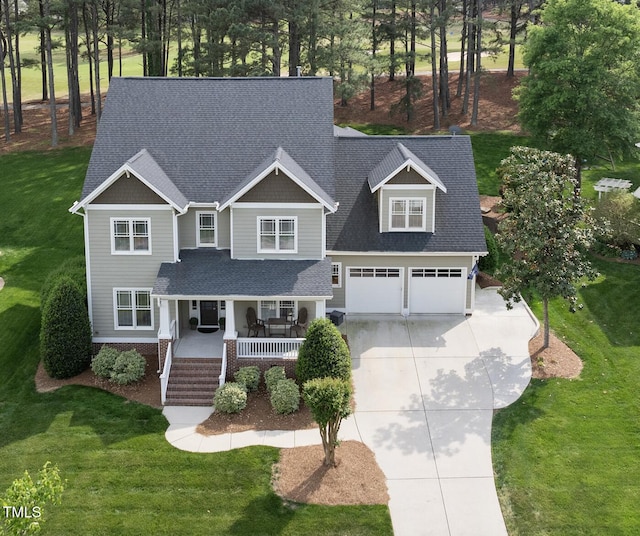 925 Hidden Jewel Ln, Wake Forest, NC 27587 - craftsman inspired home with covered porch, driveway, a shingled roof, and a front yard
