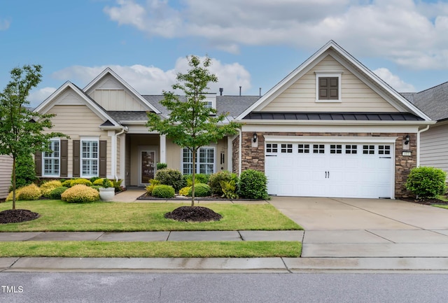 view of front of home featuring a front yard, driveway, stone siding, and a shingled roof