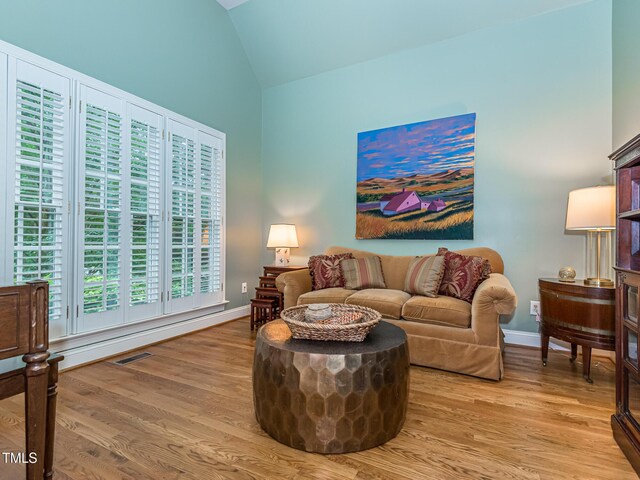 5401 Fire Pink Way, Raleigh, NC 27613 - living area featuring light wood-style flooring, high vaulted ceiling, and baseboards
