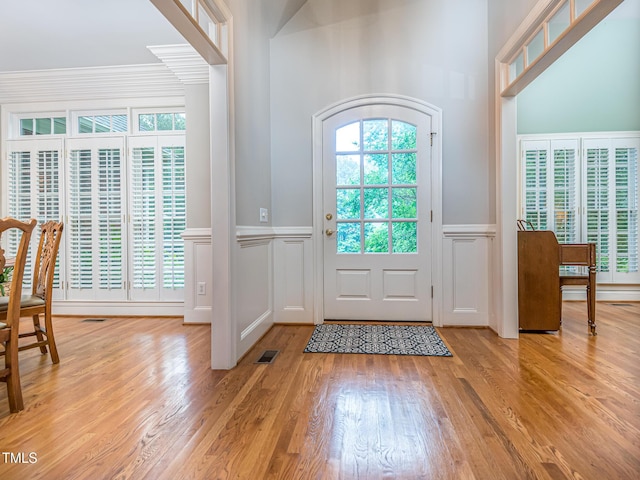 5401 Fire Pink Way, Raleigh, NC 27613 - foyer entrance featuring a decorative wall, light wood-type flooring, and a wainscoted wall