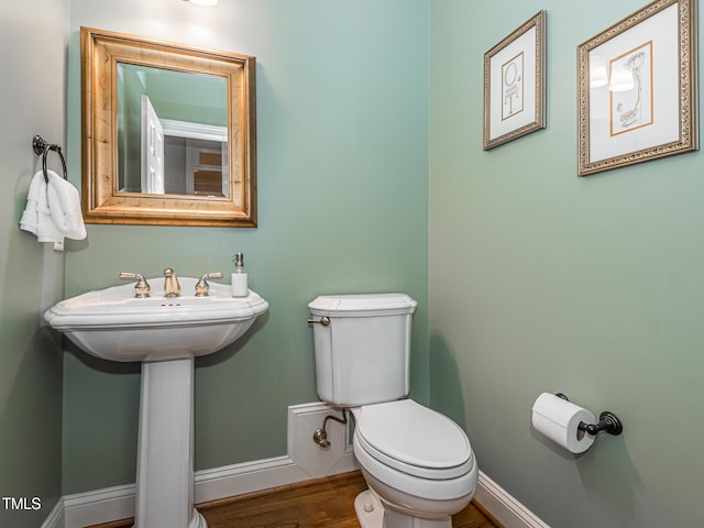 5401 Fire Pink Way, Raleigh, NC 27613 - half bathroom featuring toilet, baseboards, and wood finished floors