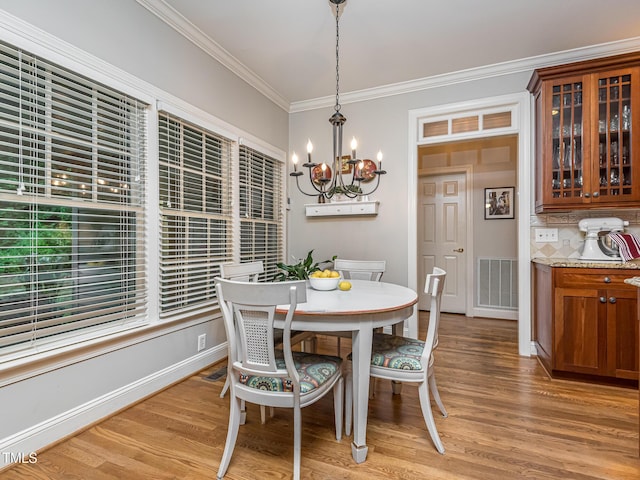 5401 Fire Pink Way, Raleigh, NC 27613 - dining area with a chandelier, crown molding, and light wood-type flooring