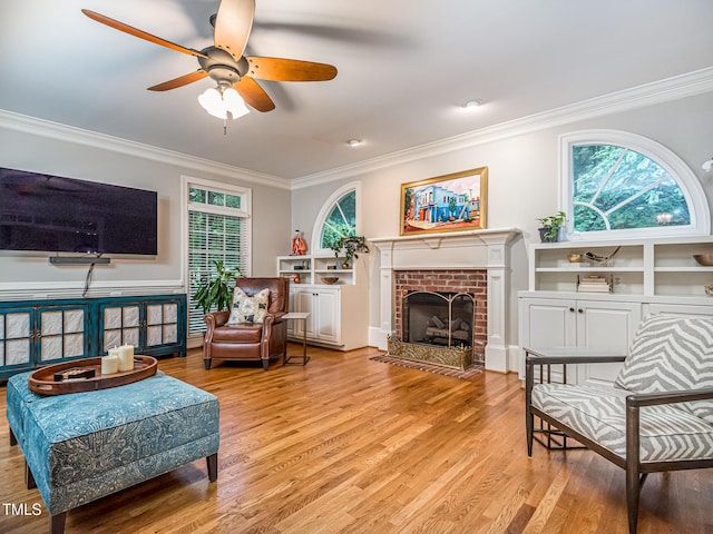 5401 Fire Pink Way, Raleigh, NC 27613 - living room featuring crown molding, a ceiling fan, light wood-type flooring, and a brick fireplace