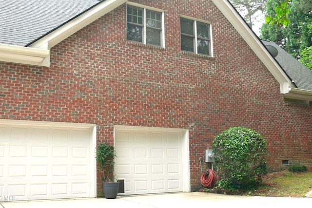 5401 Fire Pink Way, Raleigh, NC 27613 - view of property exterior with a shingled roof, brick siding, concrete driveway, and crawl space