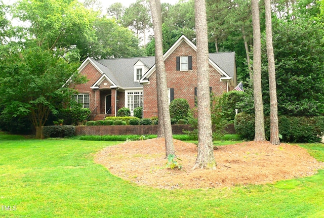 5401 Fire Pink Way, Raleigh, NC 27613 - traditional-style home featuring brick siding, a front lawn, and view of scattered trees