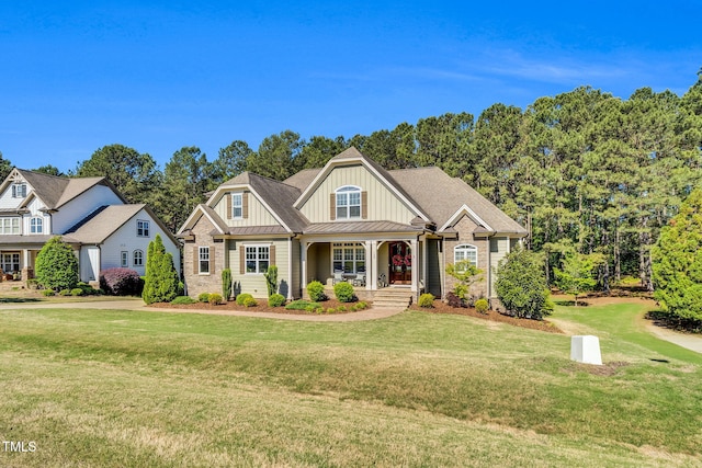 128 Paraggi Ct, Clayton, NC 27527 - craftsman-style house featuring board and batten siding, a standing seam roof, covered porch, and a front lawn