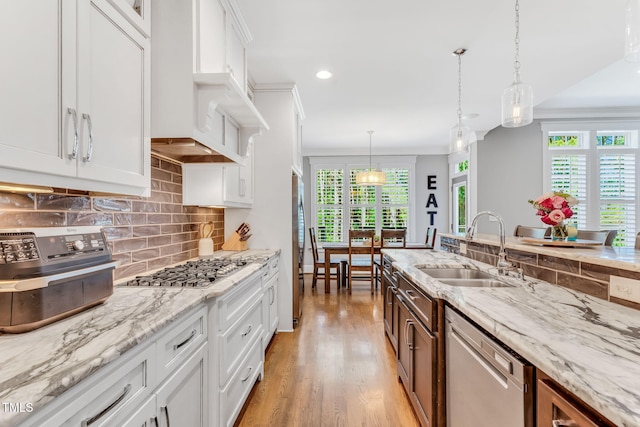 128 Paraggi Ct, Clayton, NC 27527 - kitchen featuring a sink, appliances with stainless steel finishes, white cabinetry, and a healthy amount of sunlight