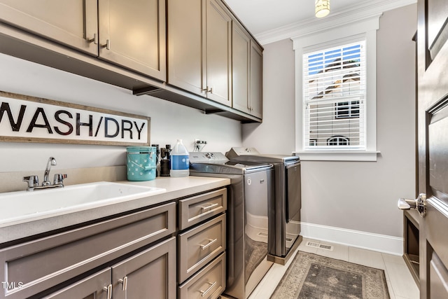 128 Paraggi Ct, Clayton, NC 27527 - clothes washing area with independent washer and dryer, cabinet space, a sink, baseboards, and ornamental molding