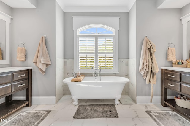 128 Paraggi Ct, Clayton, NC 27527 - bathroom with tile walls, a freestanding bath, marble finish floor, and a wainscoted wall