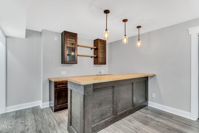 128 Paraggi Ct, Clayton, NC 27527 - bar with baseboards, indoor wet bar, and light wood-style flooring