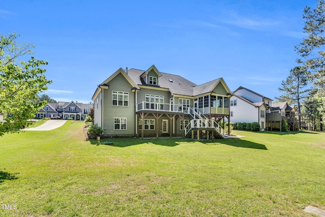128 Paraggi Ct, Clayton, NC 27527 - rear view of property with a sunroom, a lawn, stairs, and a deck