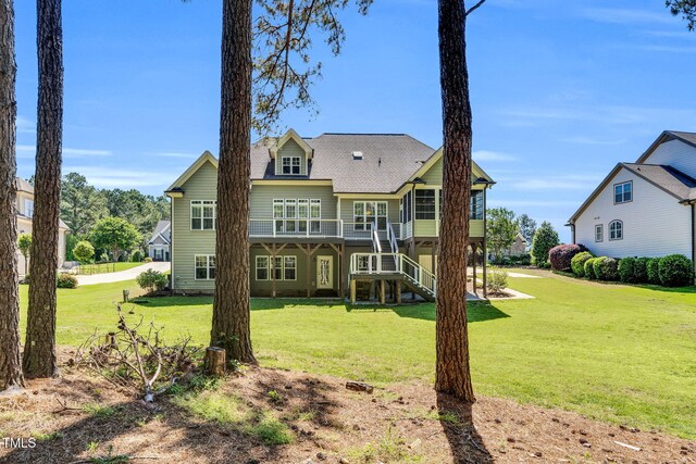 128 Paraggi Ct, Clayton, NC 27527 - rear view of house featuring a shingled roof, a yard, stairway, and a deck