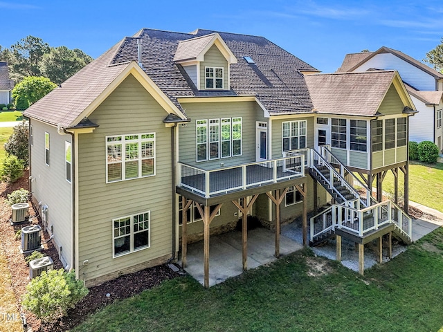 128 Paraggi Ct, Clayton, NC 27527 - rear view of house featuring a lawn, a sunroom, a patio area, and central AC