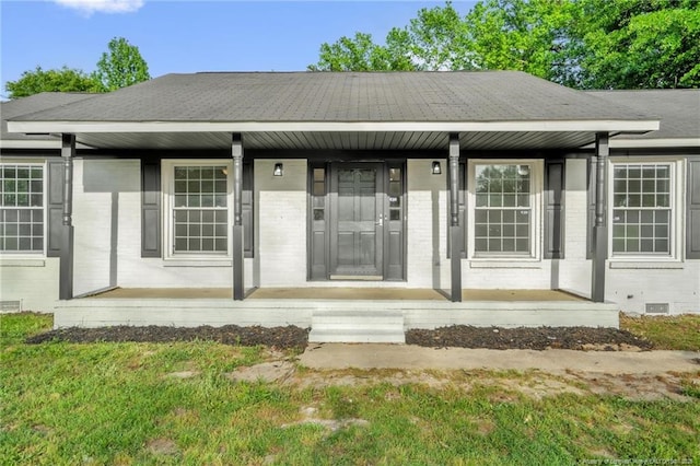 9701 Rockfish Rd, Fayetteville, NC 28376 - property entrance featuring a porch, brick siding, and crawl space