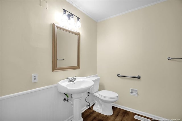 9701 Rockfish Rd, Fayetteville, NC 28376 - half bath featuring wood finished floors, toilet, and crown molding