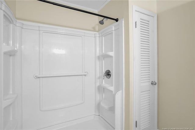 9701 Rockfish Rd, Fayetteville, NC 28376 - bathroom featuring a closet, a shower, and ornamental molding
