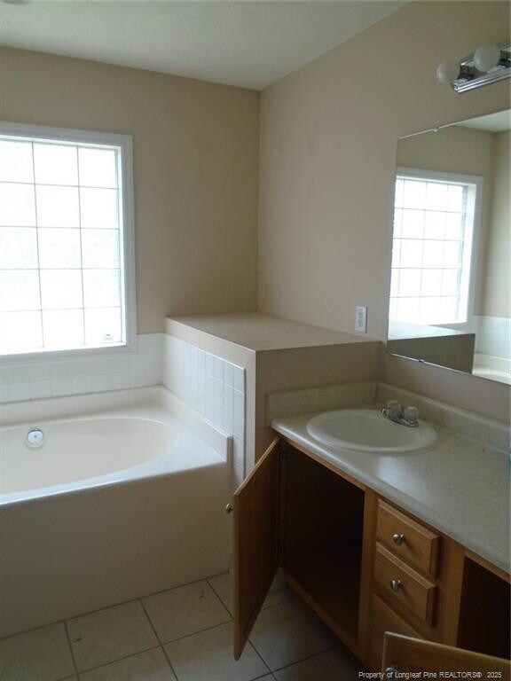 234 Walden Green Dr, Raeford, NC 28376 - bathroom featuring a bath, tile patterned flooring, and vanity