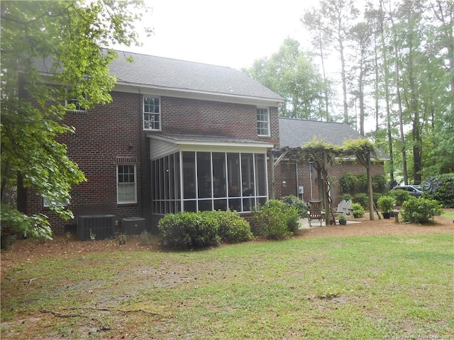 600 Yorkshire Pl, Lumberton, NC 28358 - rear view of property with a lawn, a sunroom, cooling unit, and brick siding