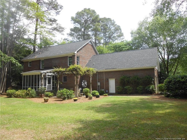 600 Yorkshire Pl, Lumberton, NC 28358 - back of house with a sunroom, a yard, and brick siding